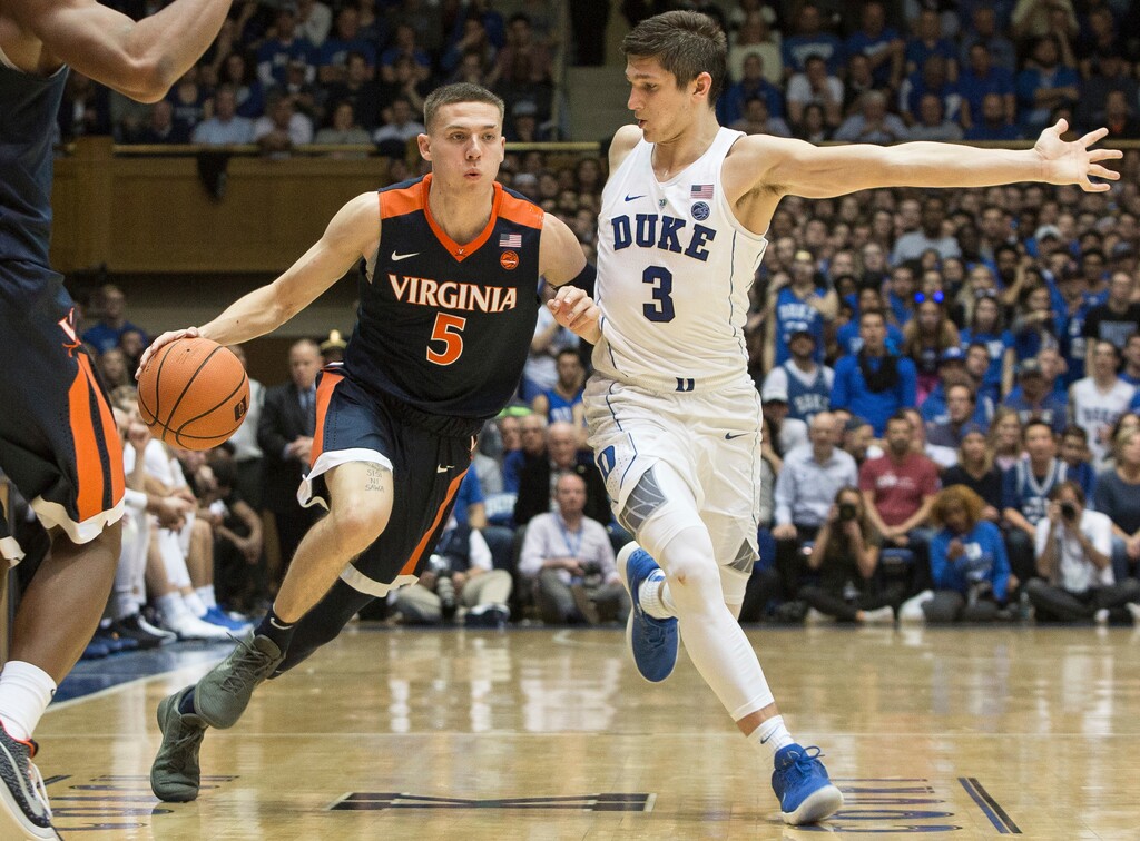Virginia's Kyle Guy (5) handles the ball against the defense of Duke's Grayson Allen (3) during the second half of an NCAA college basketball game in Durham, N.C., Saturday, Jan. 27, 2018. Virginia defeated Duke 65-63. (AP Photo/Ben McKeown)