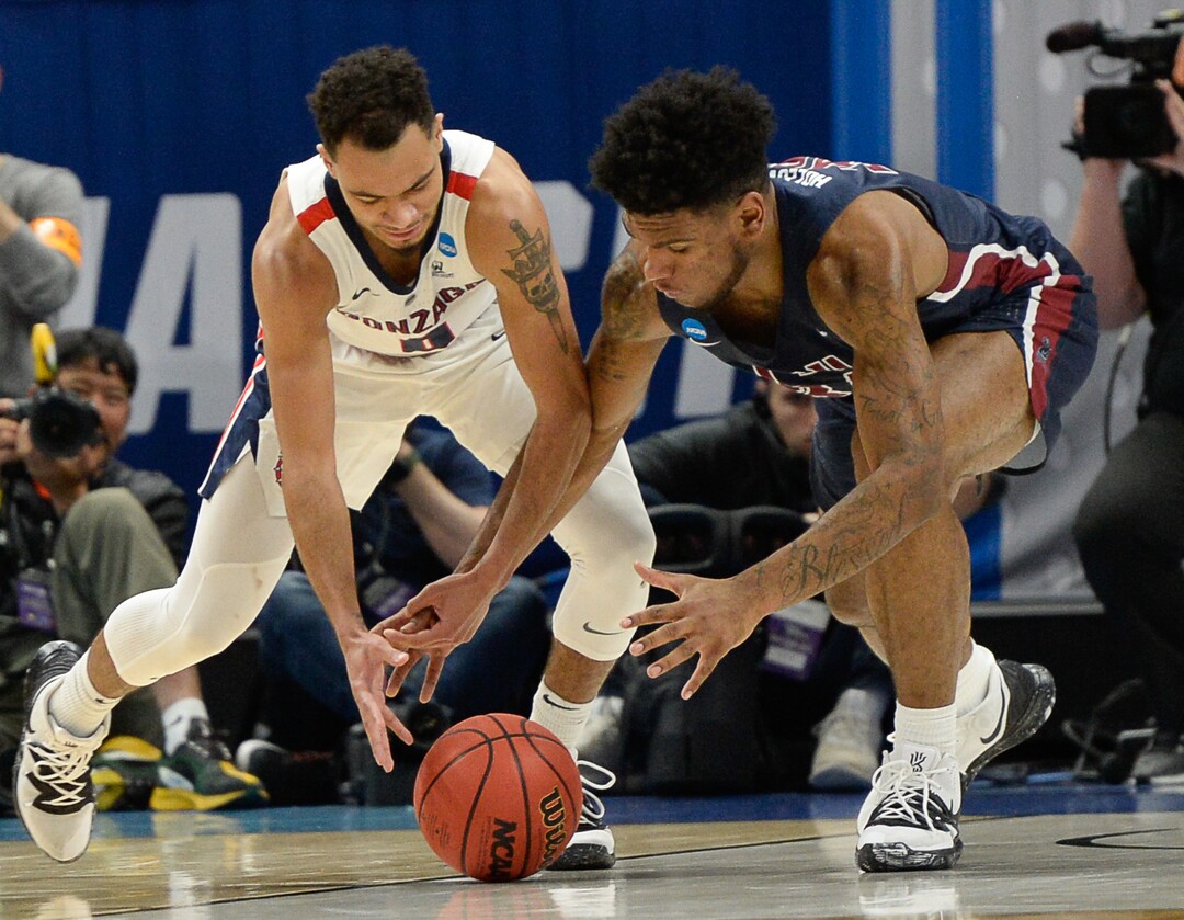 (Francisco Kjolseth  |  The Salt Lake Tribune)  Gonzaga Bulldogs guard Geno Crandall (0) battles Fairleigh Dickinson Knights forward Mike Holloway Jr. (34) for a loose ball as Gonzaga faces Fairleigh Dickinson in their first round menÕs NCAA March Madness tournament game at Vivint Smart Home Arena in Salt Lake City on Thursday, March 21, 2019.