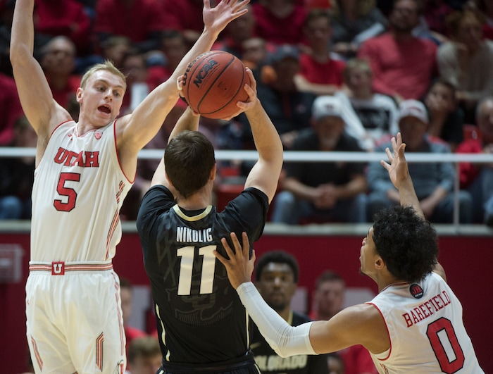 (Rick Egan  |  The Salt Lake Tribune)  Colorado Buffaloes guard Lazar Nikolic (11) shoots as Utah Utes guard Parker Van Dyke (5) and Utah Utes guard Sedrick Barefield (0) defend, in PAC-12 basketball action between Utah Utes and Colorado Buffaloes, at the Jon M. Huntsman Center, Saturday, March 3, 2018.