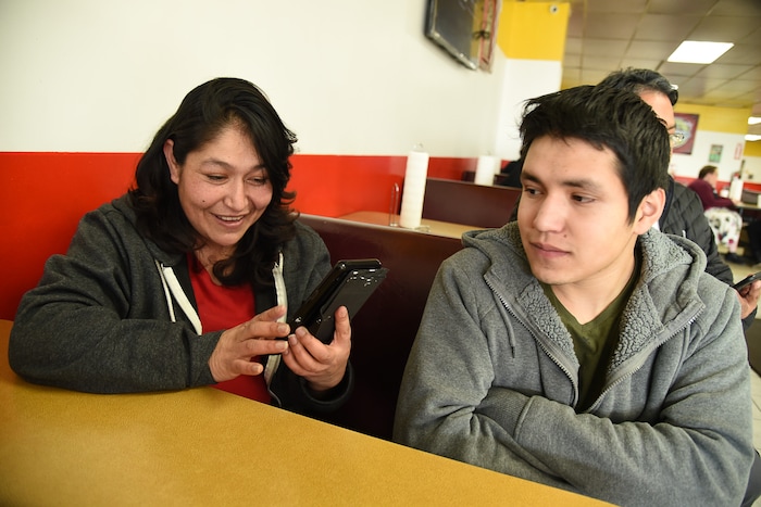 (Francisco Kjolseth  |  The Salt Lake Tribune)  Carolina Marquez looks up photos of her late husband Adrian De Los Santos Luna during the early days of their taco business back in 2015. Alongside her son Adrian who has had to step up his involvement in the family business, it has been hard on the kids since his dad committed suicide just before Christmas last year. Tacos Mi Caramelo, a late-night taqueria that is open until 2 a.m. most nights and 24-hours a day on Friday and Saturday.