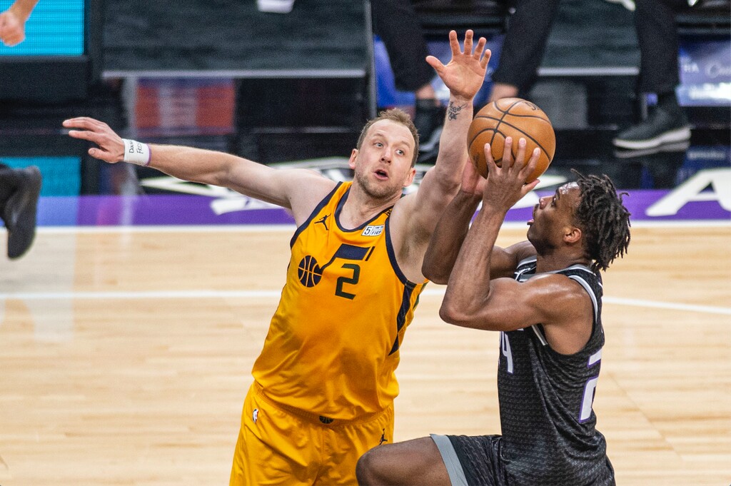 Utah Jazz guard Joe Ingles (2) defends Sacramento Kings guard Buddy Hield (24) as he goes to the basket during the first quarter of an NBA basketball game in Sacramento, Calif., Wednesday, April 28, 2021. (AP Photo/Hector Amezcua)