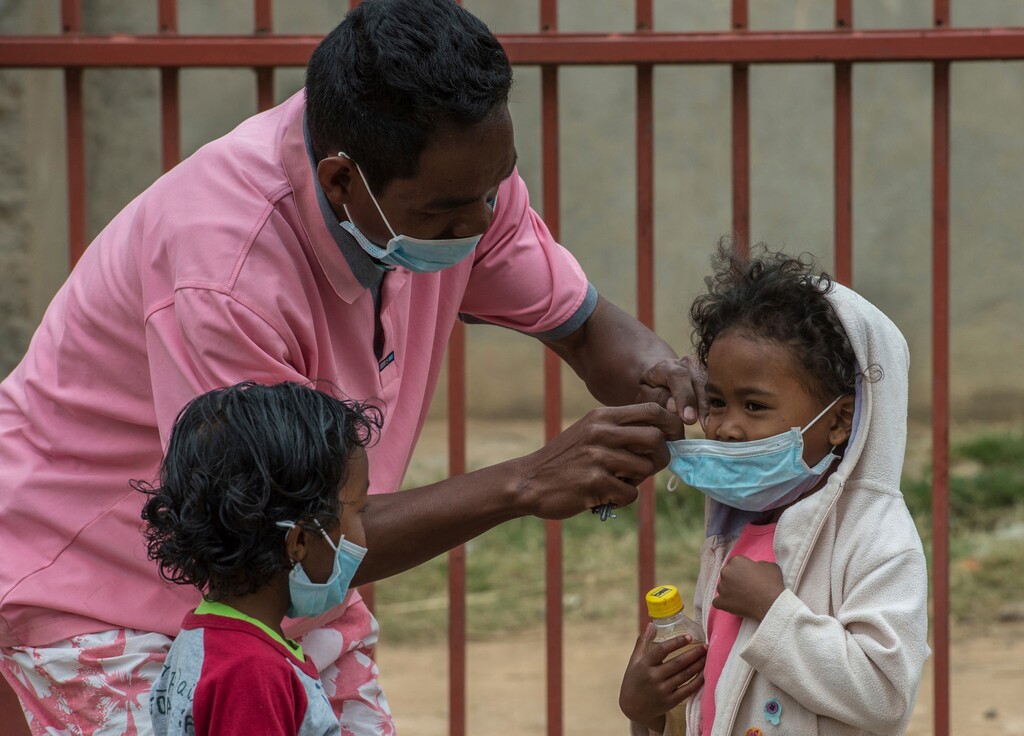 Face masks are placed on children in Antananarivo, Madagascar, Tuesday, Oct. 3, 2017.  Authorities in Madagascar are struggling to contain an outbreak of plague that has killed at least two dozen people, and the government has begun a campaign to disinfect school classrooms in the city.(AP Photo/Alexander JOE)