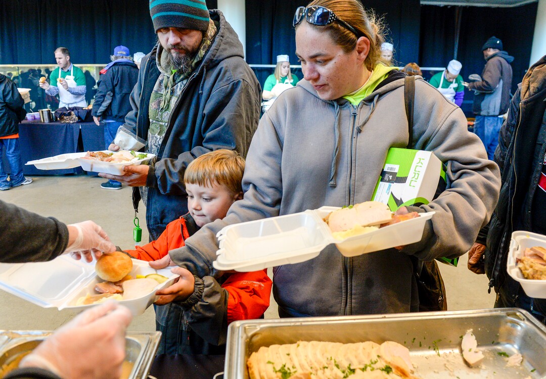 Leah Hogsten  |  The Salt Lake Tribune  Kaden Crosley, 5, fills his plate along with his parents at the  Utah Jazz and the Larry H. Miller Group sponsored annual “We Care – We Share” Thanksgiving Meal for local homeless and low-income families, Monday, Nov 19, 2018.