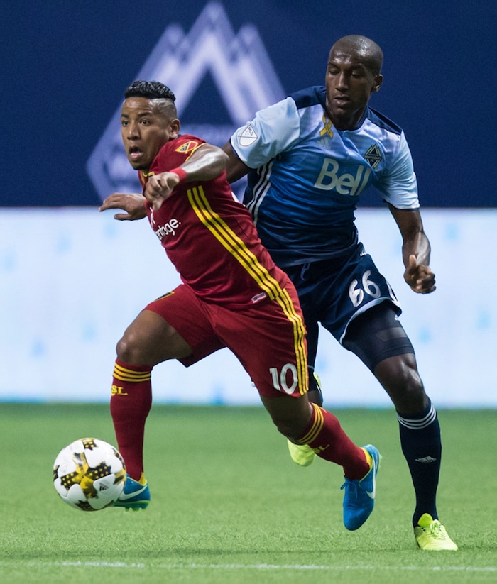 Real Salt Lake's Joao Plata (10) moves the ball past Vancouver Whitecaps' Aly Ghazal during the first half of an MLS soccer match Saturday, Sept. 9, 2017, in Vancouver, British Columbia. (Darryl Dyck/The Canadian Press via AP)