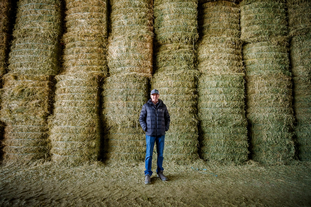 (Trent Nelson  |  The Salt Lake Tribune) Alfalfa processor Keith Bailey in a barn filled with alfalfa at Bailey Farms International in Ephraim, where bales are compressed for export to Asian dairies, on Thursday, March 2, 2023.