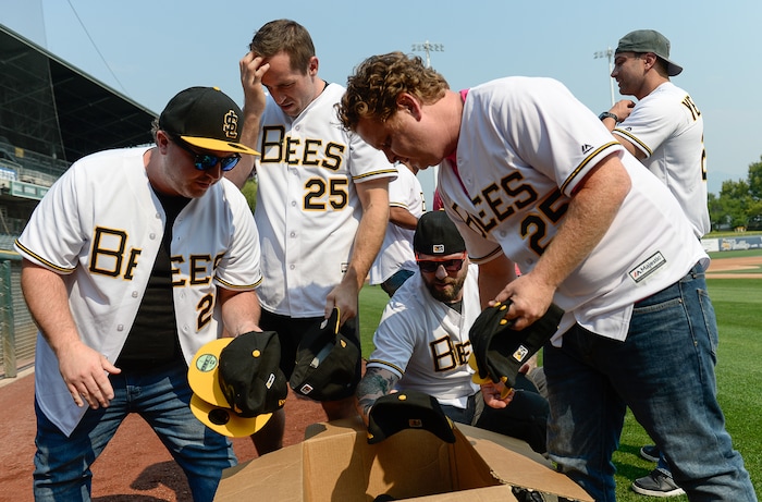 (Francisco Kjolseth  |  The Salt Lake Tribune)  The Salt Lake Bees celebrate the 25th anniversary of the Utah-filmed "The Sandlot" with members of the original cast at the Smith's Ballpark on Friday, Aug. 10, 2018. Wearing jerseys with their character names, Tommy (Shane Obedzinski), Phillips (Wil Horneff), Bertram (Grant Gelt), and Ham (Patrick Renna), from left, look for the right sized hat during a recent gathering on the field.  