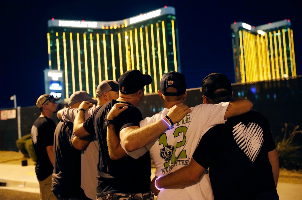 (John Locher | AP file photo)  Survivors return to the scene of a mass shooting on the first anniversary in Las Vegas on Oct. 1, 2018.