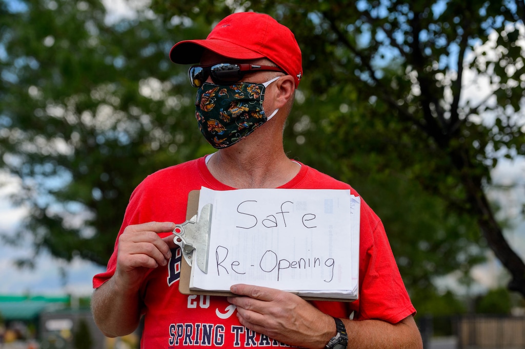 (Trent Nelson  |  The Salt Lake Tribune) Kirk Nielsen joined other teachers and parents holding signs calling for a safe plan on reopening schools prior to a Jordan School District board meeting in Riverton on Tuesday, July 28, 2020.