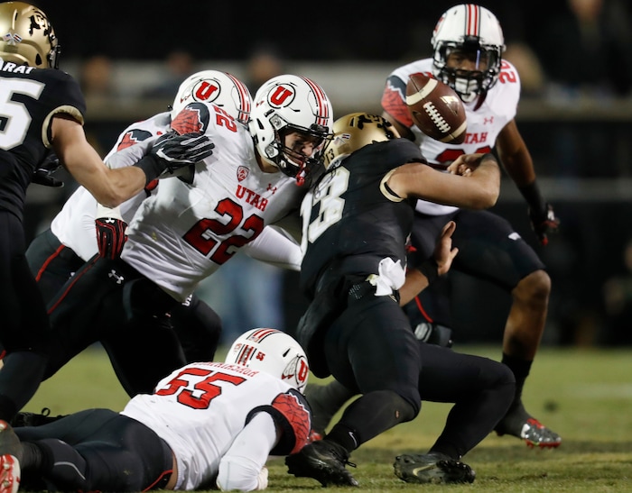 Colorado quarterback Sefo Liufau, third from left, fumbles the ball as he is hit by, from left, Utah linebacker Donavan Thompson and defensive back Chase Hansen as defensive back Marcus Williams, back, comes in to pursue the loose ball in the second half of an NCAA college football game Saturday, Nov. 26, 2016, in Boulder, Colo. Colorado won 27-22. (AP Photo/David Zalubowski)
