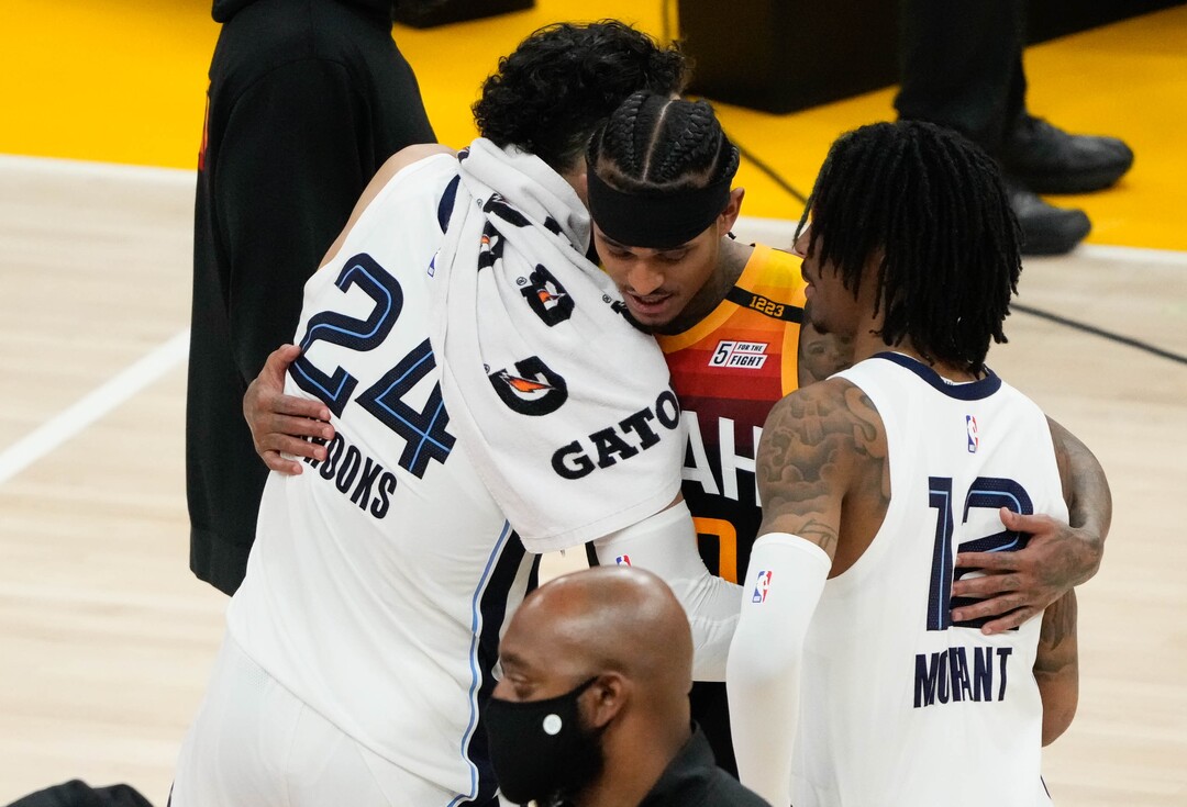 (Francisco Kjolseth | The Salt Lake Tribune) Utah Jazz guard Jordan Clarkson (00) is congratulated by Memphis Grizzlies forward Dillon Brooks (24) and Memphis Grizzlies guard Ja Morant (12) following the Jazz 126-110 to close out Game 5 of an NBA basketball first-round playoff series Wednesday, June 2, 2021, in Salt Lake City, UT.