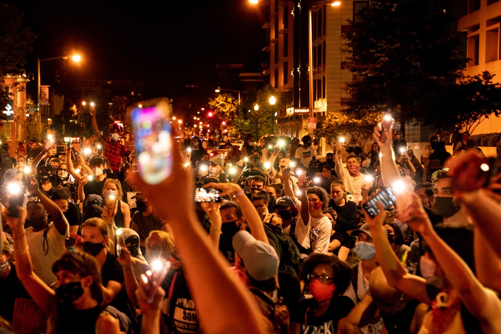(Erin Schaff | The New York Times) 

Protesters recorded a man singing during a march in Washington, D.C., on Wednesday, June 3, 2020.