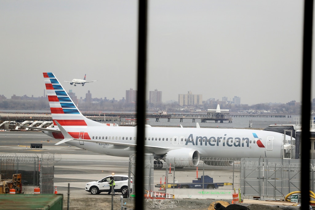 (Frank Franklin II | AP) In a March 13, 2019 file photo, an American Airlines Boeing 737 MAX 8 sits at a boarding gate at LaGuardia Airport in New York. American Airlines expects to take a $1 billion hit from two things it didn't expect when 2019 started: That its newest Boeing jet would be grounded for months after two deadly crashes, and that oil prices would rise.