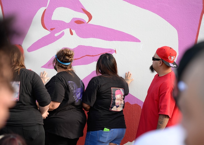 (Francisco Kjolseth  |  The Salt Lake Tribune) Family of Dillon Taylor touch the mural with his likeness on the six-year anniversary of his death alongside several murals of other people killed by police near 800 South and 300 West in Salt Lake City on Tuesday, August 11, 2020. Multiple families who’s loved one’s are depicted on the walls joined the vigil as they moved from portrait to portrait to remember them.