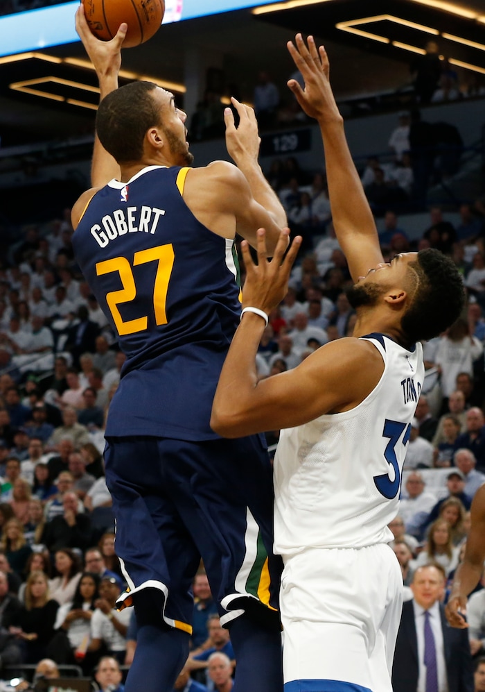 Utah Jazz's Rudy Gobert, left, of France, shoots over Minnesota Timberwolves' Karl-Anthony Towns during the first half of an NBA basketball game Friday, Oct. 20, 2017, in Minneapolis. AP Photo/Jim Mone)
