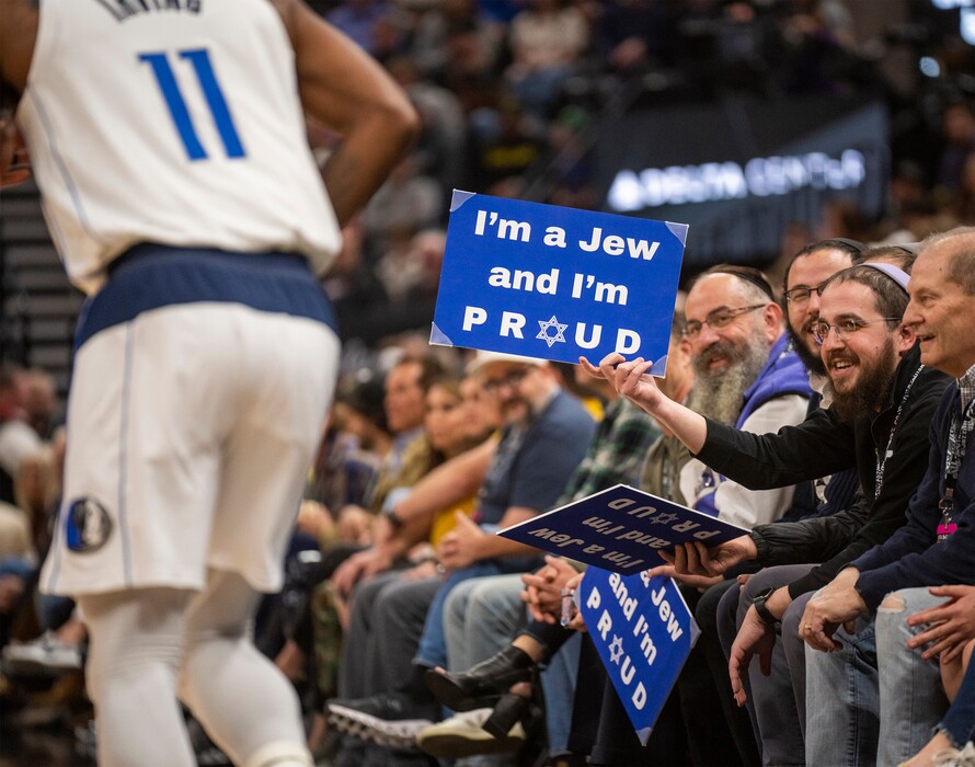(Rick Egan | The Salt Lake Tribune) Utah Rabbi Avremi Zippel and some family and friends brought signs reading "I'm a Jew and I'm proud" to Monday's Utah Jazz game, in response to anti-Semitic comments from Mavericks guard Kyrie Irving (11), Monday, Jan. 1, 2024. Zippel said Jazz and Delta Center security subsequently instructed them not to display the signs, following a complaint by Irving.