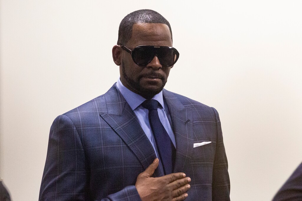 (Ashlee Rezin/Chicago Sun-Times via AP) Musician R. Kelly arrives at the Daley Center for a hearing in his child support case at the Daley Center, Wednesday, March 6, 2019, in Chicago. Kelly was charged last month with sexually abusing four females dating back to 1998, including three underage girls. He's pleaded not guilty.