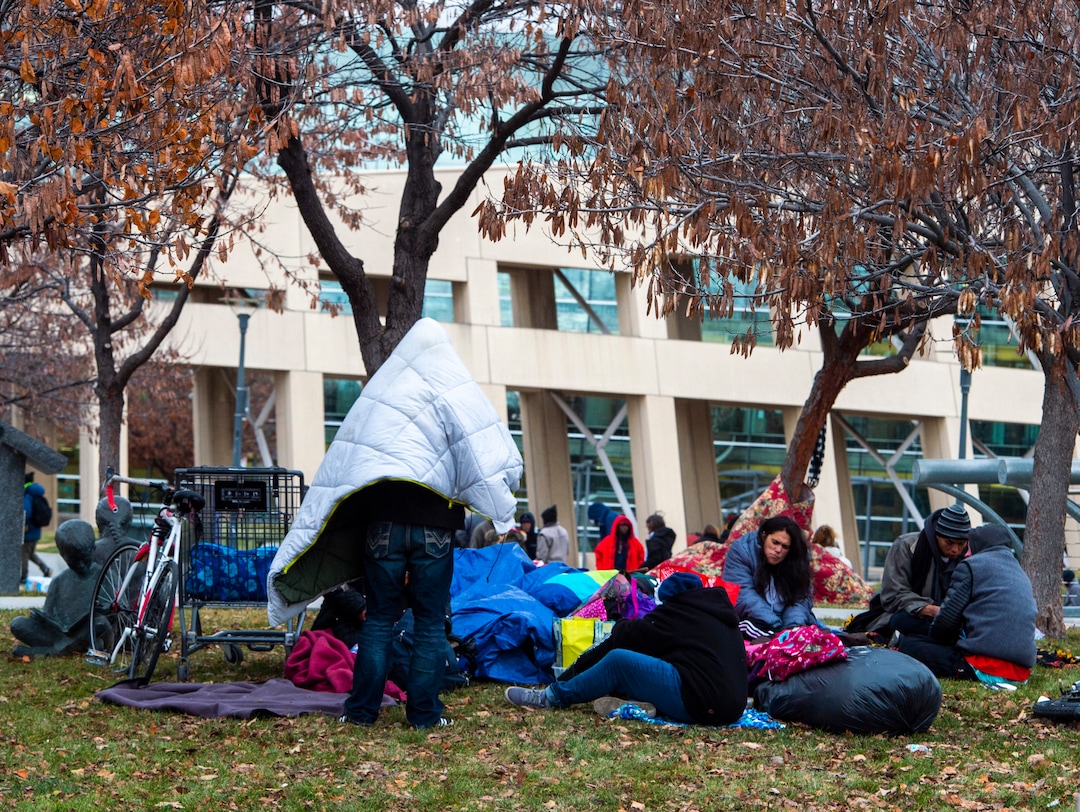 (Rick Egan | The Salt Lake Tribune) People are forced to pack up their belongings in carts and wagons near the Salt Lake City Library, Monday, Dec. 23, 2019.