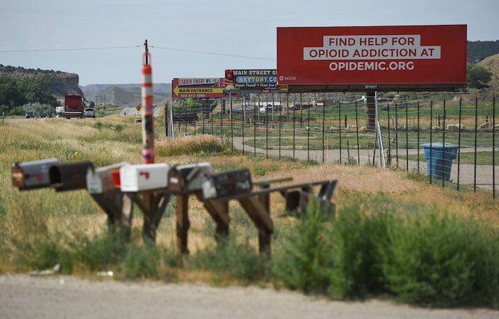 (Francisco Kjolseth | The Salt Lake Tribune)  Traffic rolls past a billboard bringing attention to the opioid crisis along U.S. Route 191 in Carbon County where at least 93 people have died to opioid overdose between 2000 and 2018, according to data from the Utah Department of Health.