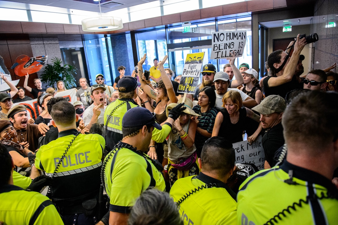 (Trent Nelson  |  The Salt Lake Tribune) Police wade in to remove Inland Port protesters occupying the Chamber of Commerce Building Salt Lake City on Tuesday, July 9, 2019.