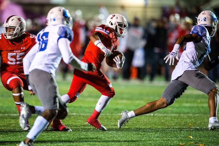 (Chris Detrick  |  The Salt Lake Tribune)  East's Sione Molisi (2) runs past IMG Academy's Shamaur Mcdowell (16) and IMG Academy's Greg Newsome II (12) during the game at East High School Friday, October 20, 2017. 