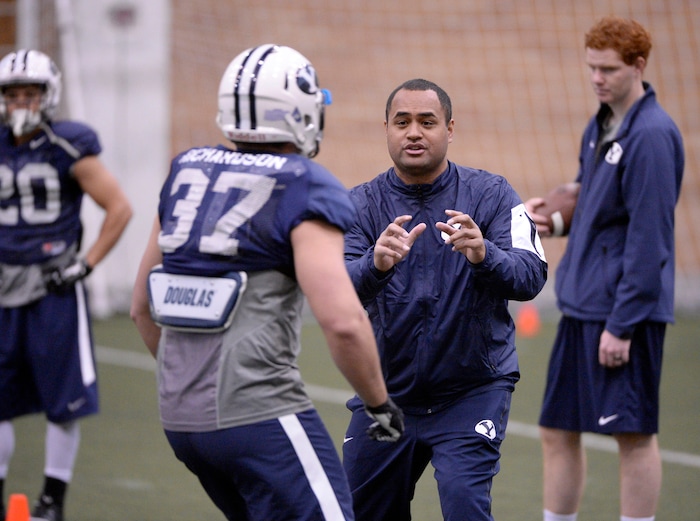 Al Hartmann  |  The Salt Lake Tribune
BYU's new running back coach Reno Mahe works with his players during practice Tuesday March 22.  