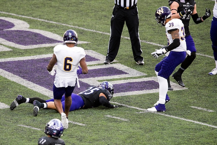 (Chris Detrick  |  The Salt Lake Tribune)  Weber State Wildcats linebacker Cameron Hansen (25) remains on the ground after failing to catch the ball on a forth and one play during the game at Stewart Stadium Saturday, November 25, 2017.  