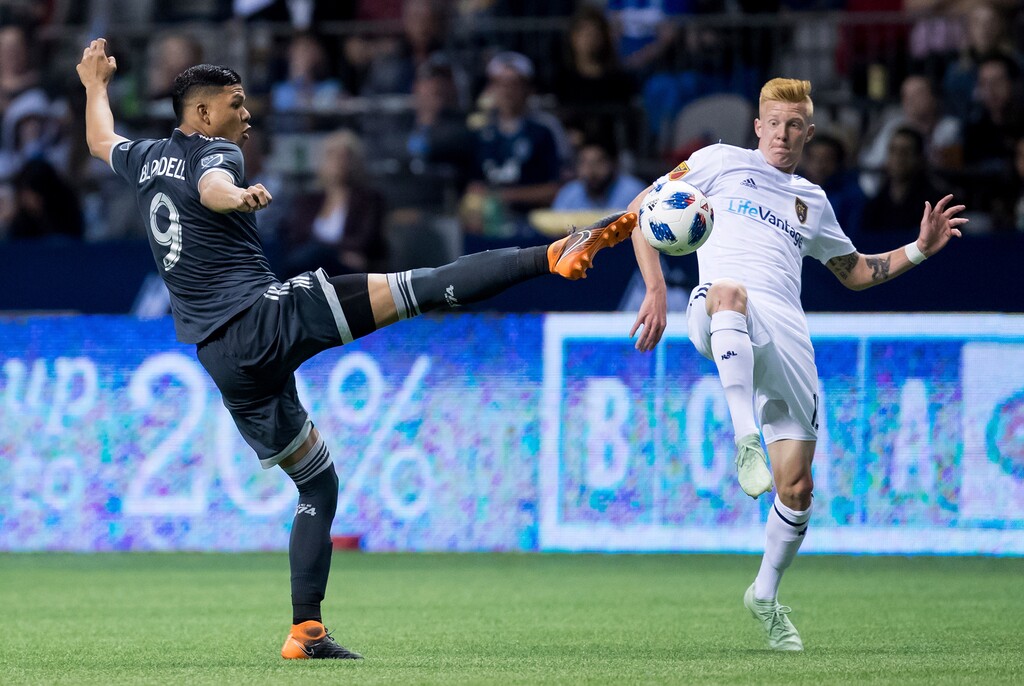 Vancouver Whitecaps' Anthony Blondell, left, and Real Salt Lake's Justen Glad vie for the ball during the second half of an MLS soccer match Friday, April 27, 2018, in Vancouver, British Columbia. (Darry Dyck/The Canadian Press via AP)