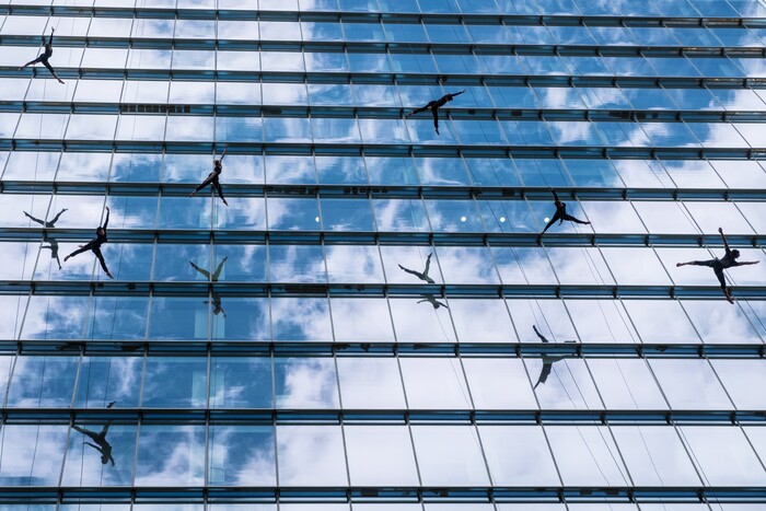 (Photo courtesy of Basil Tsimoyianis) Oakland, Calif.-based “vertical dance” company BANDALOOP performs in Sydney, Australia. They will be appearing at the Utah Arts Festival June 21-24, and will perform twice daily (5:30 and 7 p.m.) on the six-story library glass wall above the reflecting pool.