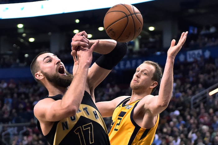 Toronto Raptors center Jonas Valanciunas (17) is fouled by Utah Jazz forward Joe Ingles (2) during the second half of an NBA basketball game Friday, Jan. 26, 2018, in Toronto. (Frank Gunn/The Canadian Press via AP)