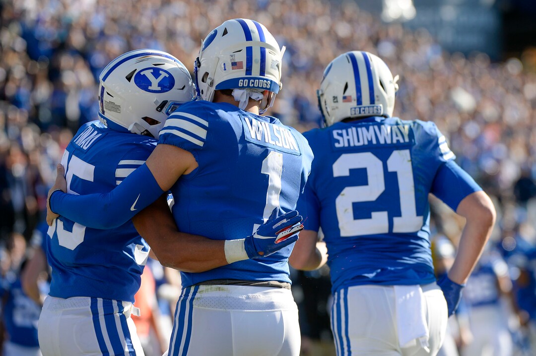 (Leah Hogsten  |  The Salt Lake Tribune) Brigham Young Cougars running back Sione Finau (35) hugs Brigham Young Cougars quarterback Zach Wilson (1) after scoring a touchdown as Brigham Young University takes on Idaho State, Saturday, Nov. 16, 2019 at LaVell Edwards Stadium.
