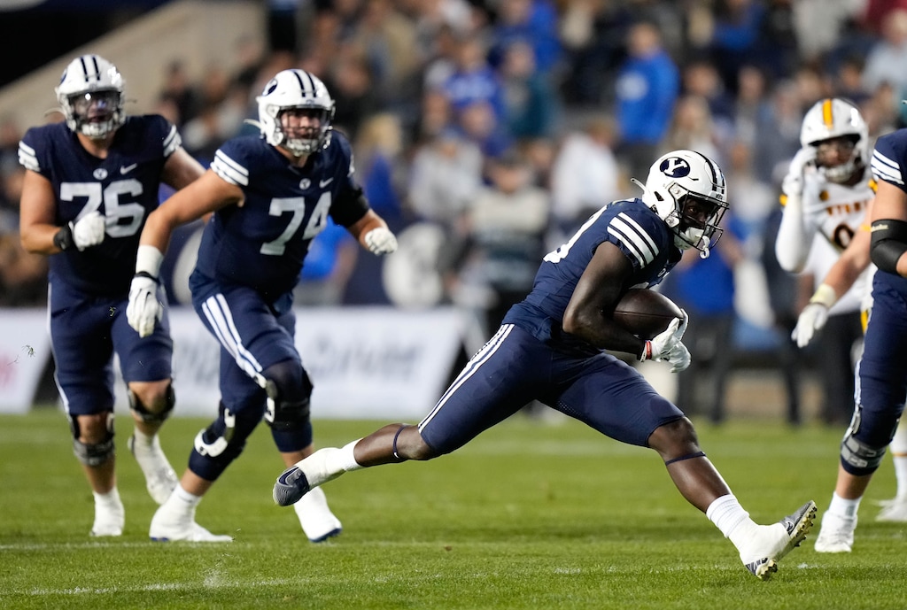 (Francisco Kjolseth | The Salt Lake Tribune) Brigham Young Cougars running back Miles Davis (19) puts in the yards as he carries the ball in football game action between the Brigham Young Cougars and the Wyoming Cowboys at LaVell Edwards Stadium in Provo, on Saturday, Sept. 24, 2022.