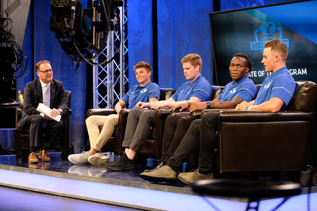 (Francisco Kjolseth | The Salt Lake Tribune) Dave McCann, left, interviews BYU quarterback Zach Wilson, tight end Matt Bushman, defensive back Dayan Ghanwoloku and linebacker Zayne Anderson, from left, during a live broadcast on BYUTV during BYU football media day at the BYU Broadcasting Building in Provo on Tuesday, June 18, 2019.
