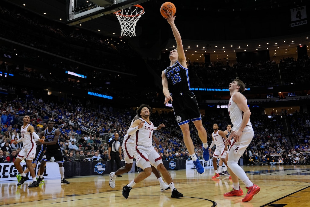 (Julia Demaree Nikhinson | AP) Brigham Young forward Richie Saunders (15) puts up a shot against Alabama guard Mark Sears (1) and forward Grant Nelson (4) during the first half of a Sweet 16 round NCAA college basketball tournament game, Thursday, March 27, 2025, in Newark, N.J.