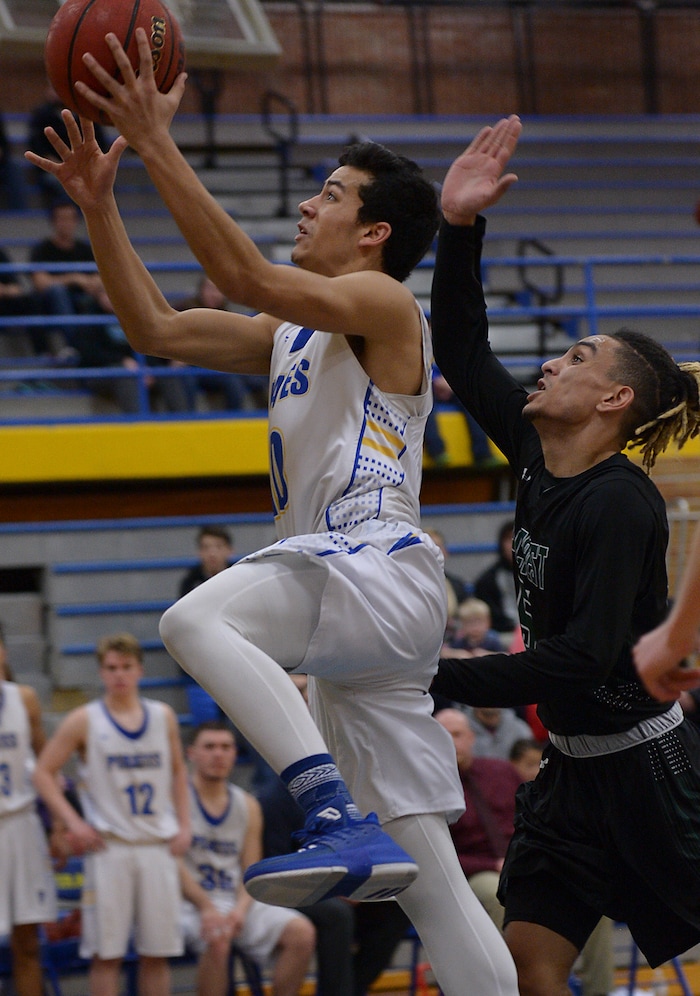 (Leah Hogsten | The Salt Lake Tribune) Cyprus' Josh Amasio hits the net. Cyprus High School boys' basketball team defeated Hillcrest High School 77-61 during their game Tuesday, January 30, 2018 in Magna.