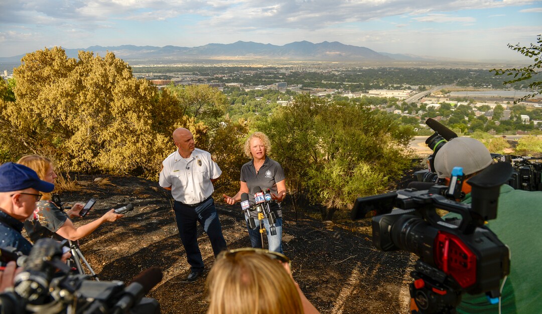 Leah Hogsten  |  The Salt Lake Tribune  l-r Salt Lake City Mayor Jackie Biskupski and Salt Lake City Fire Chief Karl Lieb hold a press conference in the burned area near Salt Lake City’s Ensign Peak. Five people were injured and one home was damaged by a fast-moving grass fire on Columbus Court, Tuesday, July 24, 2018. Forty homes were evacuated as flames spread through about 100 acres. Between 50 and 60 firefighters responded to the fire.