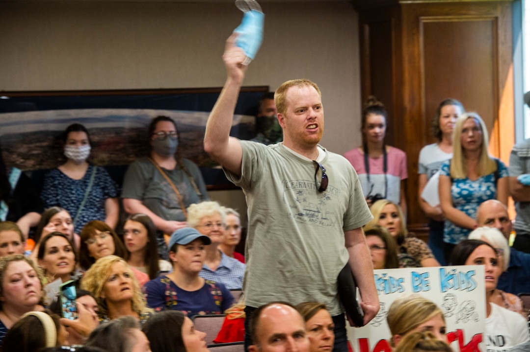 (Rick Egan  |  The Salt Lake Tribune)    Angry residents react when the Utah County Commission meeting was adjourned before it even started. The group protesting against masks being required in schools removed the social distancing tape on the chairs and filled the Utah County Commission room to over flowing, prompting Commissioner Tanner Ainge to call for a vote to adjourn the meeting in Provo, on Wednesday, July 15, 2020.