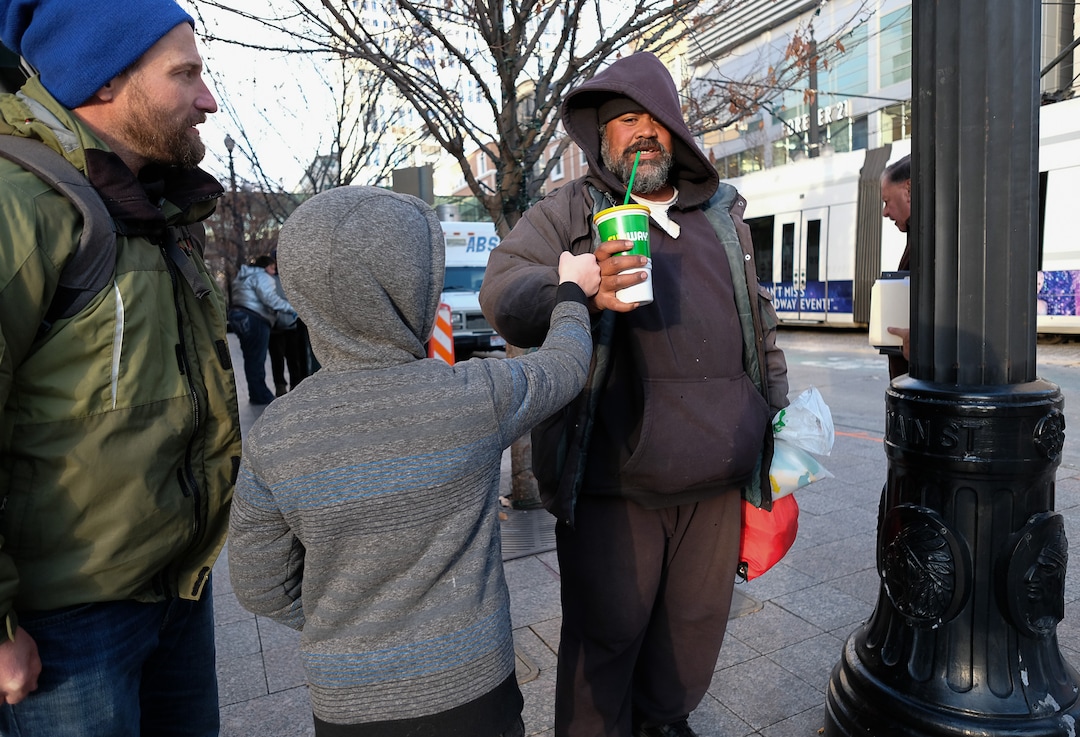 (Francisco Kjolseth  |  The Salt Lake Tribune) Ten-year-old Chase Hansen and his father John walk say goodbye to Viliami Taufalele, right, after approaching him in downtown Salt Lake City and buying him a meal in exchange for a little conversation on Monday, Dec. 16, 2019. Chase started an organization at the age of 6 called Project Empathy. The two of them spend time with people experiencing homelessness in an effort to connect with people on a personal level.