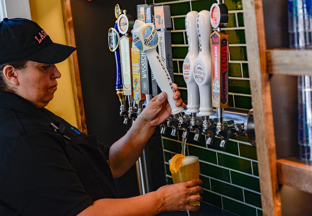 (Francisco Kjolseth  |  The Salt Lake Tribune)  Hortesia Dille pours a draft beer for a customer as Lagoon Amusement Park new Biergarten on Thursday, June 20, 2019.