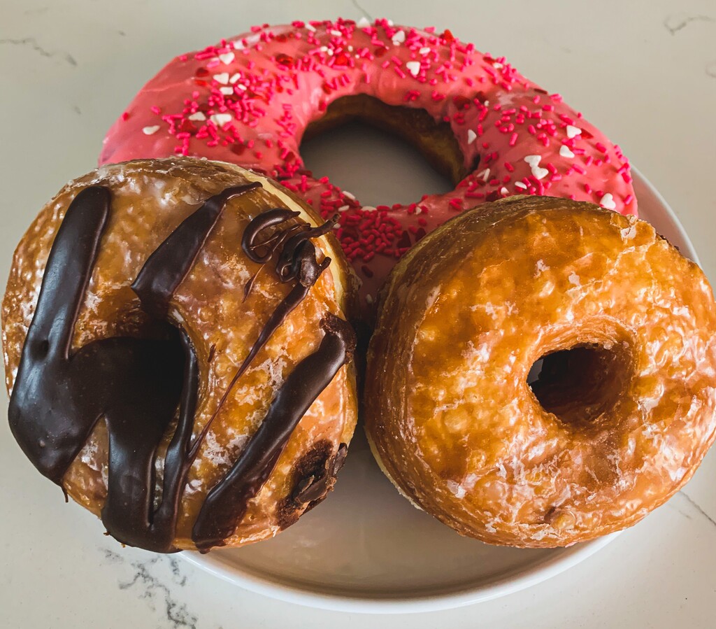 (Aimee L. Cook) A Texas-sized doughnut, top, and layered cronuts are among the specialties at Donut Star Café in Draper.