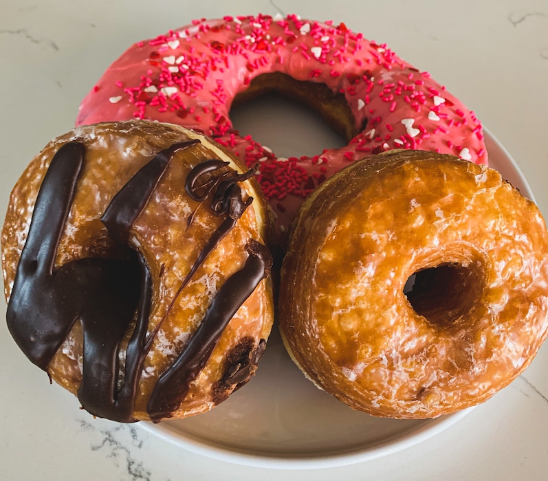(Aimee L. Cook) A Texas-sized doughnut, top, and layered cronuts are among the specialties at Donut Star Café in Draper.