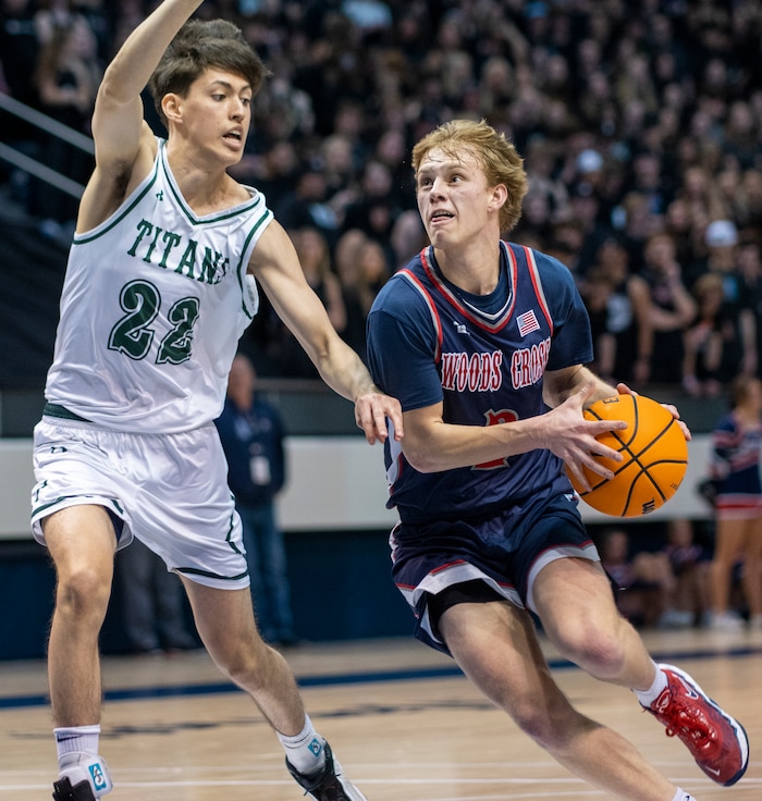 (Rick Egan | The Salt Lake Tribune) 
Woods Cross guard, Zach Delange (2) goes to the hoop, as Olympus Titan Olympus forward, Lucas McKane (22) defends, in the 5A State Championship game between Woods Cross and Olympus, at the Marriott Center in Provo, on Saturday, March 5, 2022.