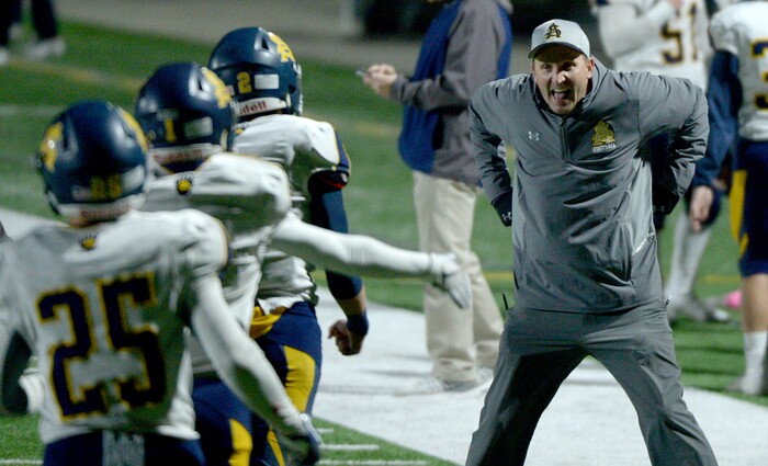 (Leah Hogsten | The Salt Lake Tribune) Summit Academy's head coach Les Hamilton celebrates a touchdown quarterback Hayden Reynolds. Summit Academy boys' football team leads Juan Diego High School 51-43 during their game, October 13, 2017 in Draper.