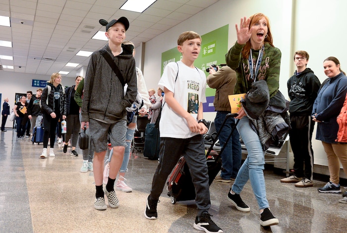 (Leah Hogsten | The Salt Lake Tribune) Jennie Taylor, the widow of Maj. Brent Taylor, waves at friends as she, her sons Lincoln, Alex and three other children arrive at the airport. Ten Gold Star families from Salt Lake City were treated to a Winter Wonderland scene, including Whoville and the Grinch at their boarding gate at Salt Lake International Airport, Dec. 7, 2019 before their flight to Disney World aboard the Snowball Express. This month, the Gary Sinise Foundation's Snowball Express will fly more than 1,700 family members of fallen U.S. military heroes to Disney World for a holiday retreat.