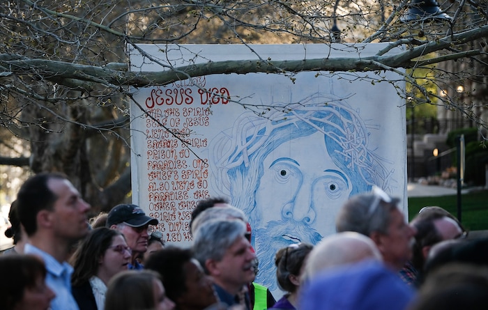(Francisco Kjolseth  |  The Salt Lake Tribune)  Christians march through streets of Salt Lake City on Good Friday to symbolically mark Jesus' carrying the cross to his crucifixion beginning at Cathedral of the Madeleine.