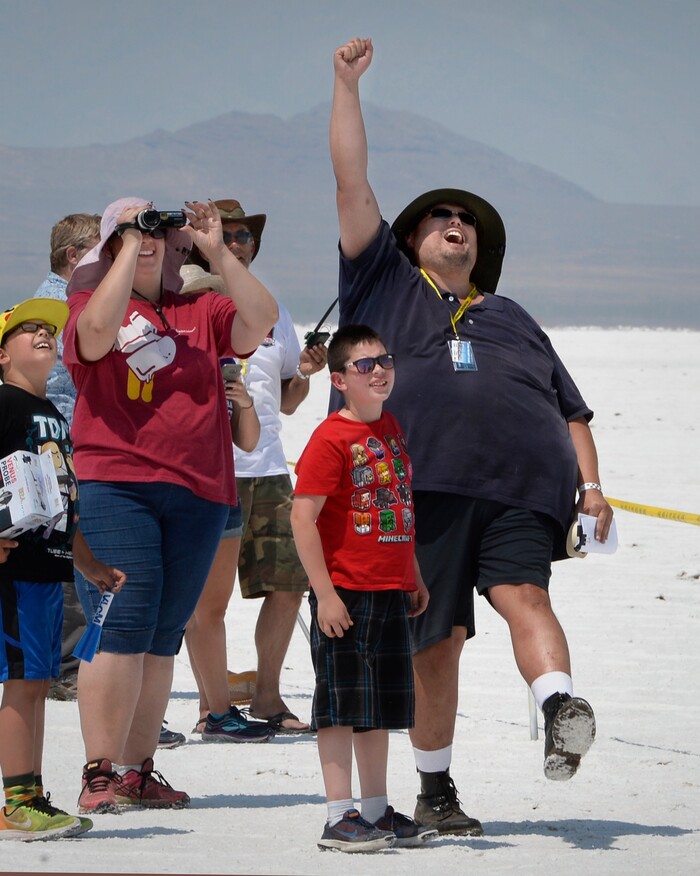 (Scott Sommerdorf   |  The Salt Lake Tribune)   Travis Tabbal lets out a scream as he celebrates the flight of his "Fireball" rocket while his wife, Kelly, left, and sons watch the flight and successful parachute deployment during "HellFire" — the event sponsored by the Utah Rocket Club on Saturday, Aug. 5, 2017.