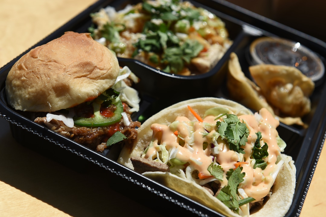 (Francisco Kjolseth  |  The Salt Lake Tribune) The bento box sampler from the Umai food truck includes a slider, taco, teriyaki rice bowl and potstickers.