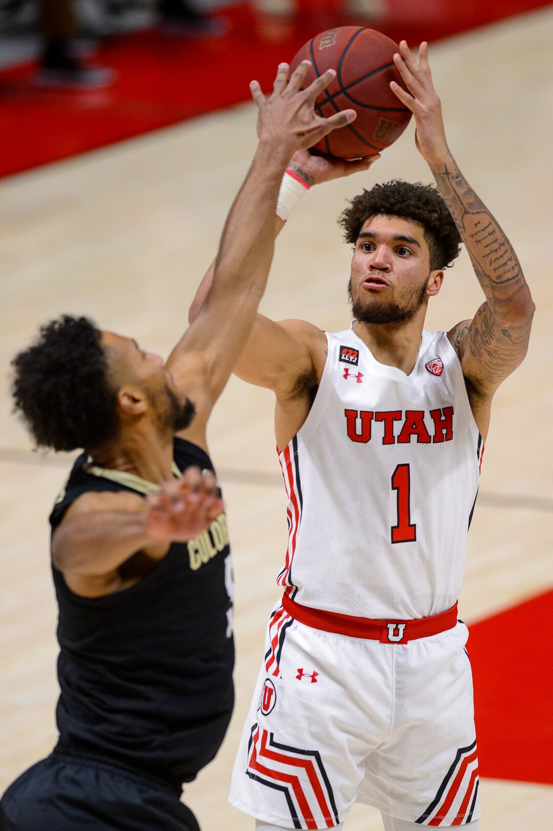 (Trent Nelson  |  The Salt Lake Tribune) Utah Utes forward Timmy Allen (1) shoots over Colorado Buffaloes guard D'Shawn Schwartz (5) as Utah hosts Colorado, NCAA basketball in Salt Lake City on Monday, Jan. 11, 2021.