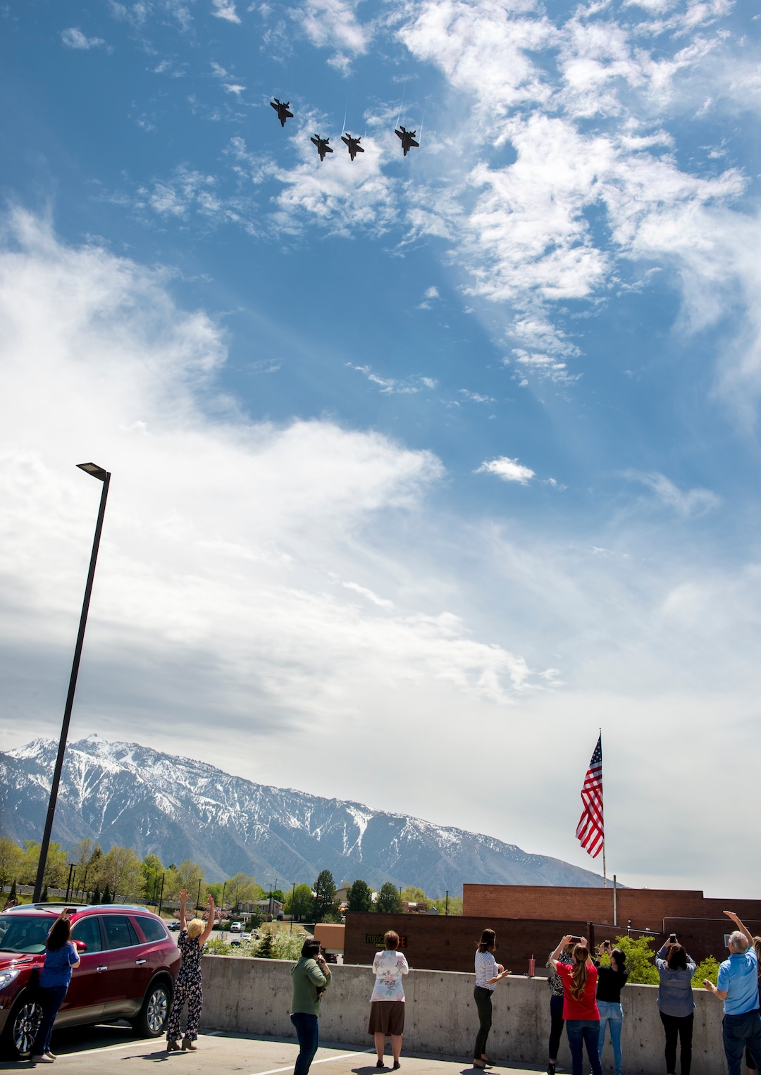 (Chris Samuels | The Salt Lake Tribune) People watch as a U.S. Air Force F-35 Demonstration Team flies over the Salt Lake Valley in Cottonwood Heights, Thursday, April 30, 2020.