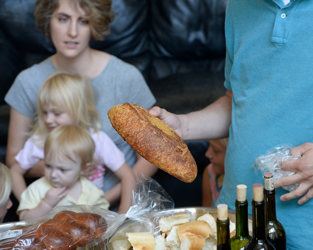 (Al Hartmann  |  The Salt Lake Tribune)
At a Remnant fellowship gathering in Sandy, the sacrament bread is broken into large pieces and fruit juice or wine is passed around.