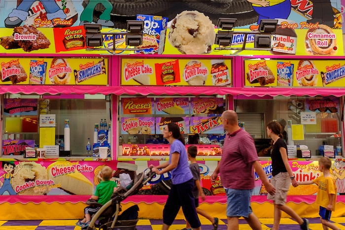 (Trent Nelson | The Salt Lake Tribune) A family takes in the sweet offerings on opening day at the Utah State Fair in Salt Lake City, Thursday September 7, 2017.